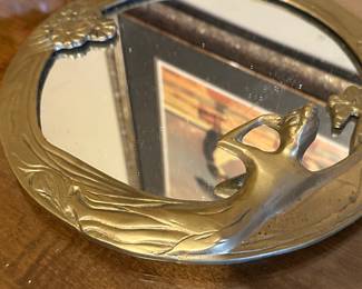Preliminary walkthrough photo: 

Art Deco Style Brass mirror with woman figure. 