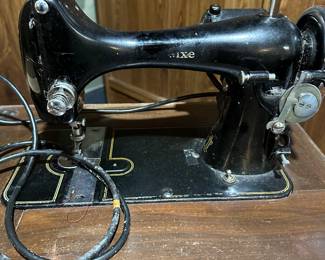 Vintage REVERSEW Electric Sewing Machine with Original Manual. Comes compete with wooden sewing table and some accessories.  