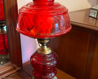 Preliminary walkthrough photo: 

Red glass hurricane styled electric lamp! 