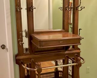 Incredible wooden hall tree with brass rails and beveled mirrors