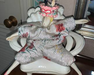 Weird beanbag person sitting in a porcelain chair. Talk about Kitch!