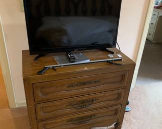 Dresser and one of 3 tvs