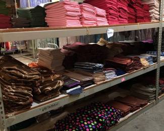 3 Shelves of 54in Square Tablecloths