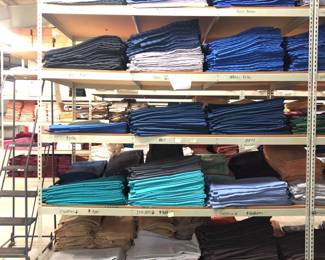 Five Shelves of 108in Round Tablecloths