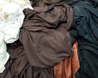 Large Pile of Unprocessed Brown Table Linens