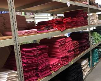 Four Shelves of 72in Square Tablecloths