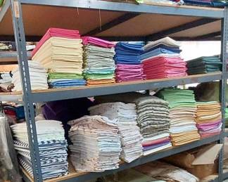 Tablecloths and Remnants Located On One Side of Shelving Unit