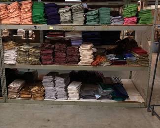 Three Shelves of 54in Square Tablecloths
