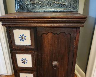 Small, antique tiled cabinet