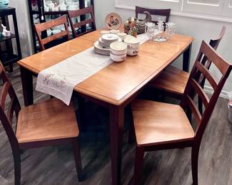 Light wood table with 6 chairs and leaf extension inside table 