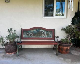 wood and metal bench, potted plants