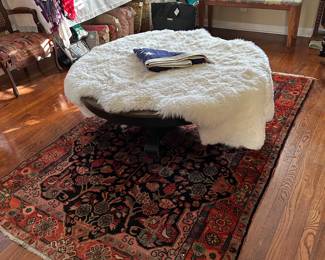 Oriental rug, semi antique  measures approximately  5' x 8', sheepskin rug, on a low pedestal antique wood table 4' diameter and 19" tall 