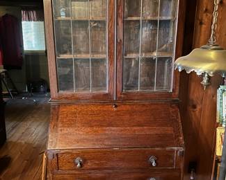 Oak secretary with leaded glass doors and drop pulls