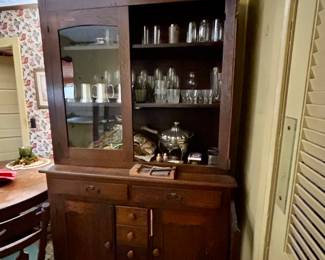 kitchen cupboard. missing door is next to the cabinet. missing trim piece is in a drawer. 
