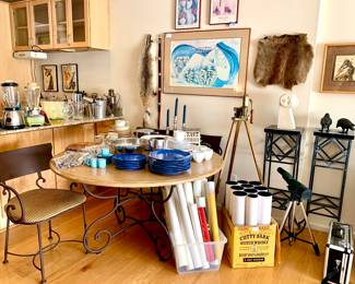 Cast Iron Crows perched on top of metal column. Cement hand sculpted art figure. Wrought iron chairs and eating table. Bushnell Scope on top of tripod. Travel posters. Stand up wine opener on tripod