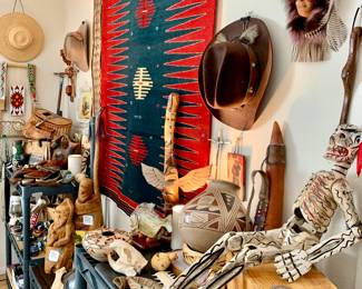 Length view of the really incredible collection of native American. Spirit mask, cowboy hats, walking stick, walking dead skeleton, snake head, Acoma pottery.