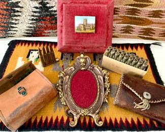 Antique bullet pouches. Indian Rugs. Bronze picture frame. Antique red velvet jewelry box