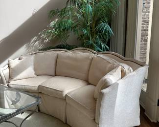 Neutral curved sofa with nailhead trim 