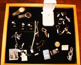 The jewelry case is filled with both gold and silver jewelry.  The rings in the right hand corner are mostly 10 karat and the bracelets in the middle are 14 kt. gold.  