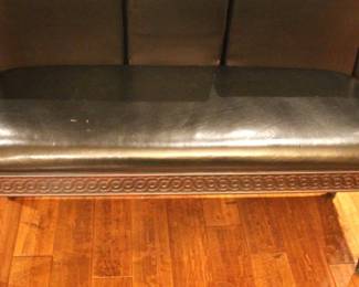 Black leather like upholstered bench.