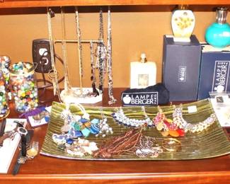 Costume jewelry, watches, three jars of marbles, Lampe Bergers and more.