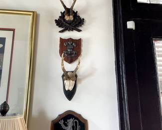 Top to Bottom: Coat of arms "Bon Accord" 3 castle keeps on red field $100, Antique fancy Black Forest antler mount $395, Wales coat of arms pewter crown with feathers S100, Black Forest antler mount $195, Scotland coat of arms pewter lion $185.