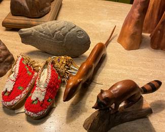 Antique Native American Plains Tribal Beaded Baby Moccasins, $195, Hand-Carved Wooden Weasel by R. Crowe. $375, Hand-Carved Wooden Raccoon by John Cowden $150. Chiseled Stone Fish, $75
