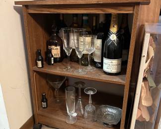Wooden shelving unit, bottles of wine, wine glasses
