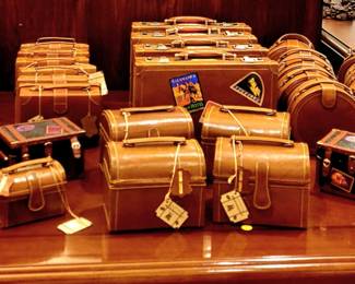 Amazing array of 100% leather boxes, purses with crossbody straps, various sizes. Some are plain, some are, decorated with travel stickers! Small, Medium and Large sizes. Whimsical! 