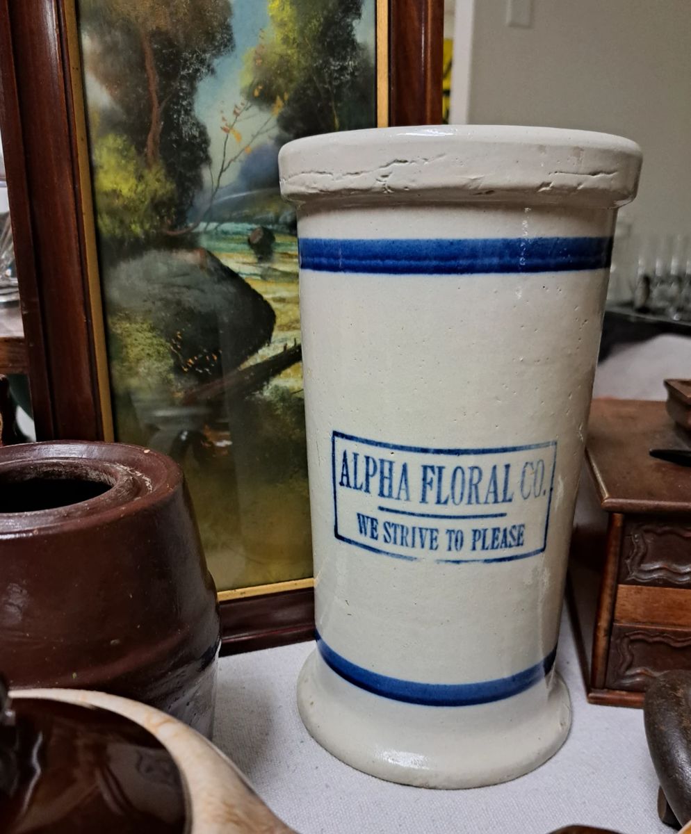 1/2 OFF ALL REMAINING ITEMS SATURDAY!!
2 Day Large Estate/ Household Sale. Much stoneware "Alpha Floral Co. We Strive To Please" blue band crock vase
