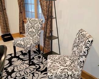 Pair of accent chairs. Floor rug. Floor lamp with shelves