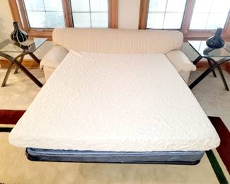 White leather sleeper sofa with mattress topper
