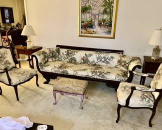 Antique/vintage side chairs and sofa with carved feed and rolled arm rests, wooden side tables, glass lamps, vintage upholstered top stool