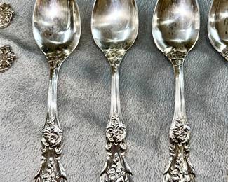 Close-up view of Reed & Barton Francis I pattern on sterling silver spoons