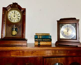 Close-up view of Antique clocks (need work), antique books