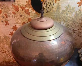 The spirits in this copper and brass pot are kept from ravaging the ends of the earth only by the black and white cookie inspired lid. Look to the cookie.