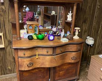 Pretty antique dresser covered in crystal shoes and purses.