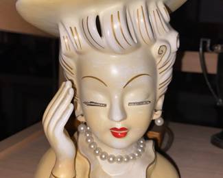 Head vase with raised hand and jewelry 