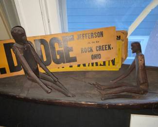 Close up of folk art figures in long boat