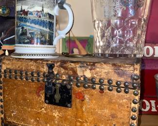 Close up of glass ice bucket with silver trim , antique lidded box,German stein 