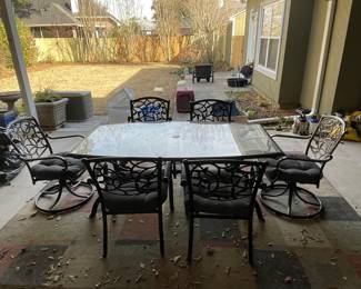 $395 Outdoor boat shaped glass top table 72x40x27H
	6 chairs with arms (incl 2 swivel ones)
