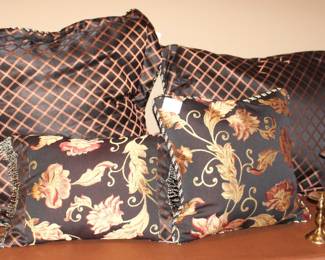 Custom made pillows shown with brass candlesticks.