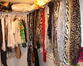 This closet has a large amount of scarves, area rugs, afghans, blankets, and pillows.