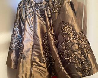 Elegant taupe satin women's cloak with medallion design and four buttons
