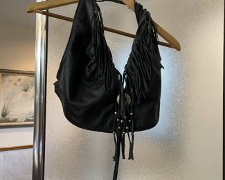 Leather halter top with buckle, beads and fringe detail.
