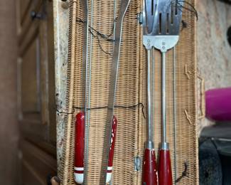 Vintage BBQ equipment in round wicker basket
