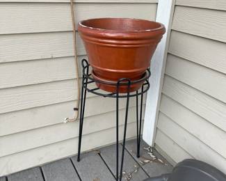 Outdoor pots on wrought iron stands