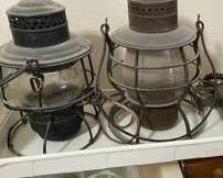 Vintage railroad lanterns. One is electric, the other oil.