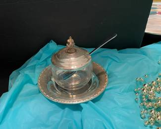 Silver plate condiment jar with small tray and silver spoon.