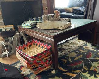 Colorful ethnic woven baskets, glass top wooden coffee table